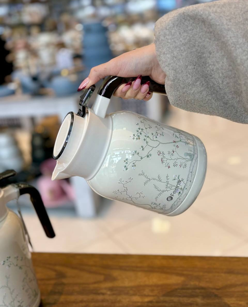 Feenik Vacuum Flask 2.0L held with both hands showing full floral design