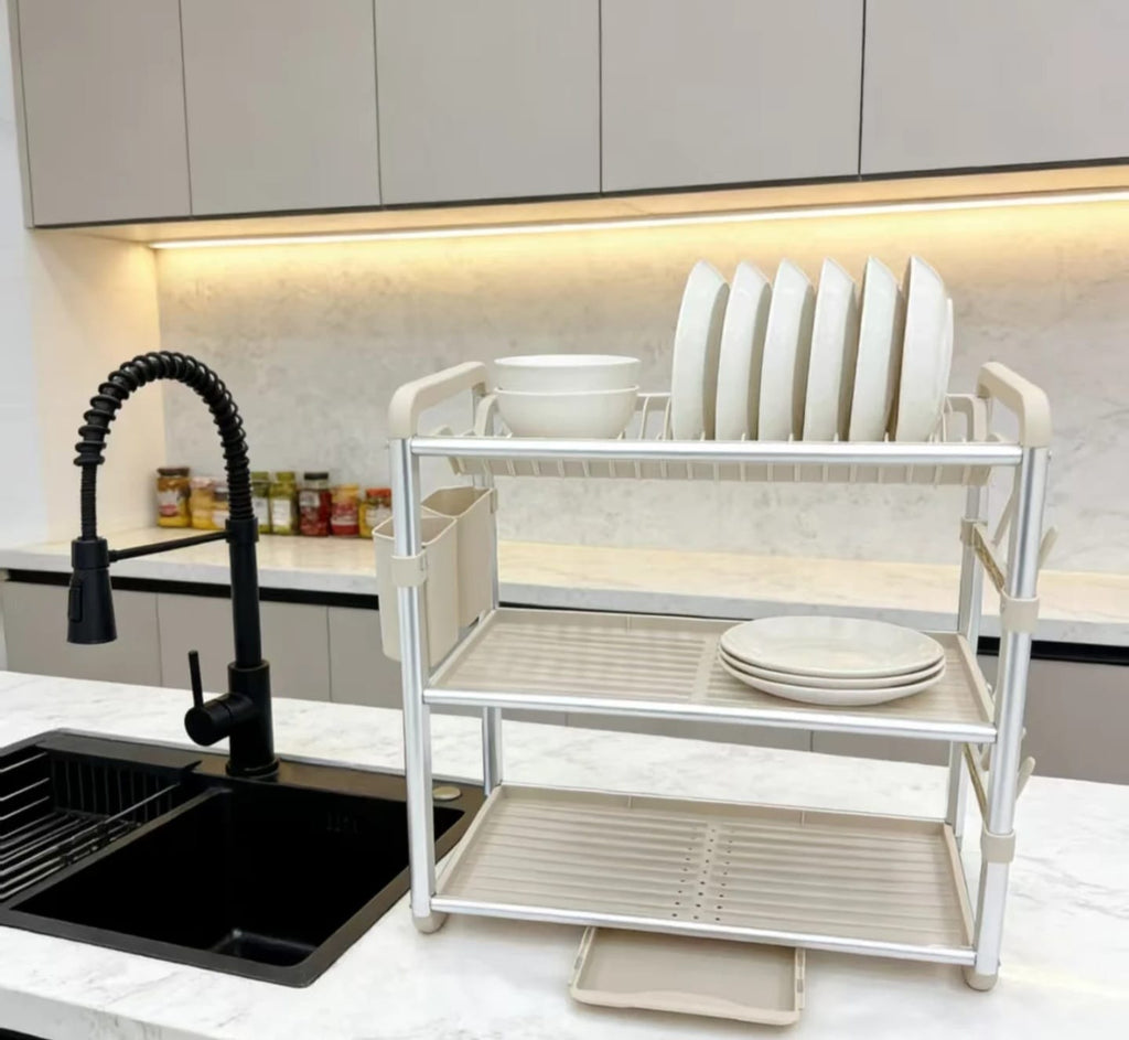 3-Tier Aluminum Dish Drying Rack on marble countertop next to black sink - loaded with plates and bowls
