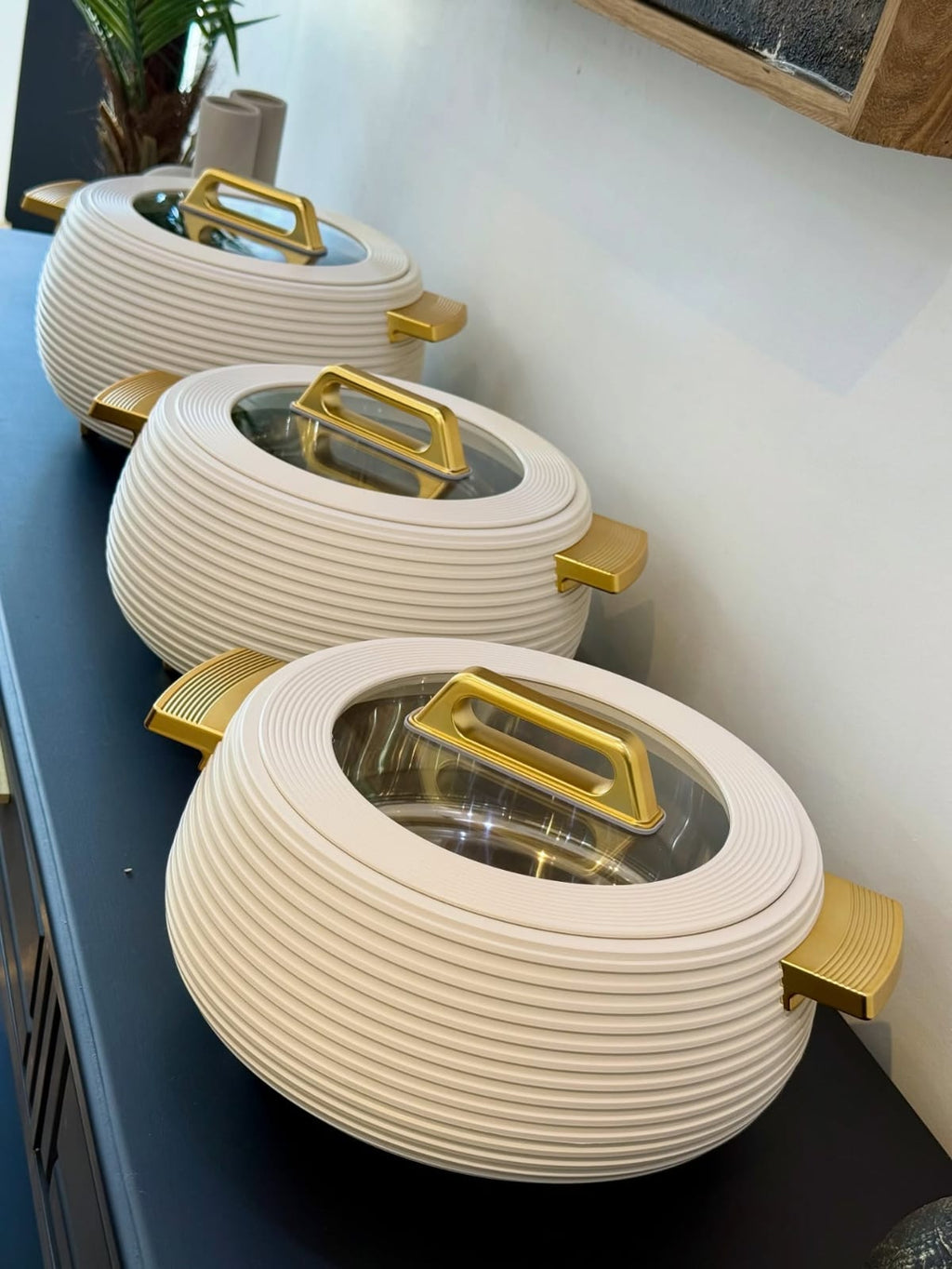 3pcs White and Gold Ribbed Hotpot Set lined up on dark shelf - lifestyle display