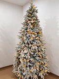 Premium snow-flocked PVC Christmas tree illuminated with warm-looking lights