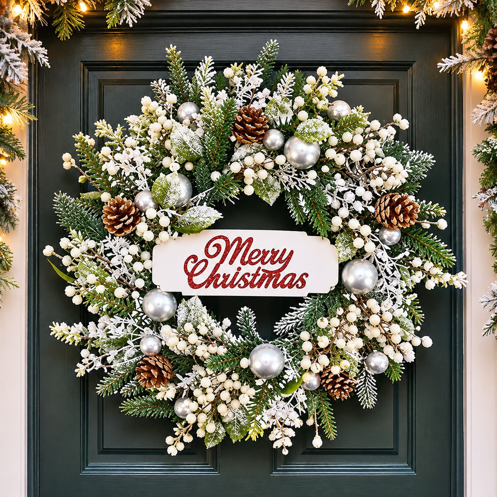 Christmas wreath with snowy greenery, silver baubles, pine cones, ivory berries and a Merry Christmas sign