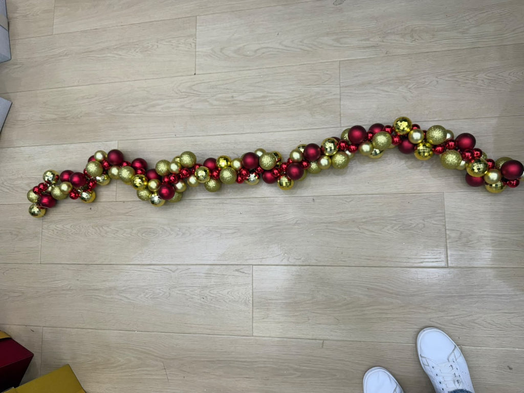 Red and gold Christmas ball garland laid out full length, 1.8m of mixed 6cm baubles